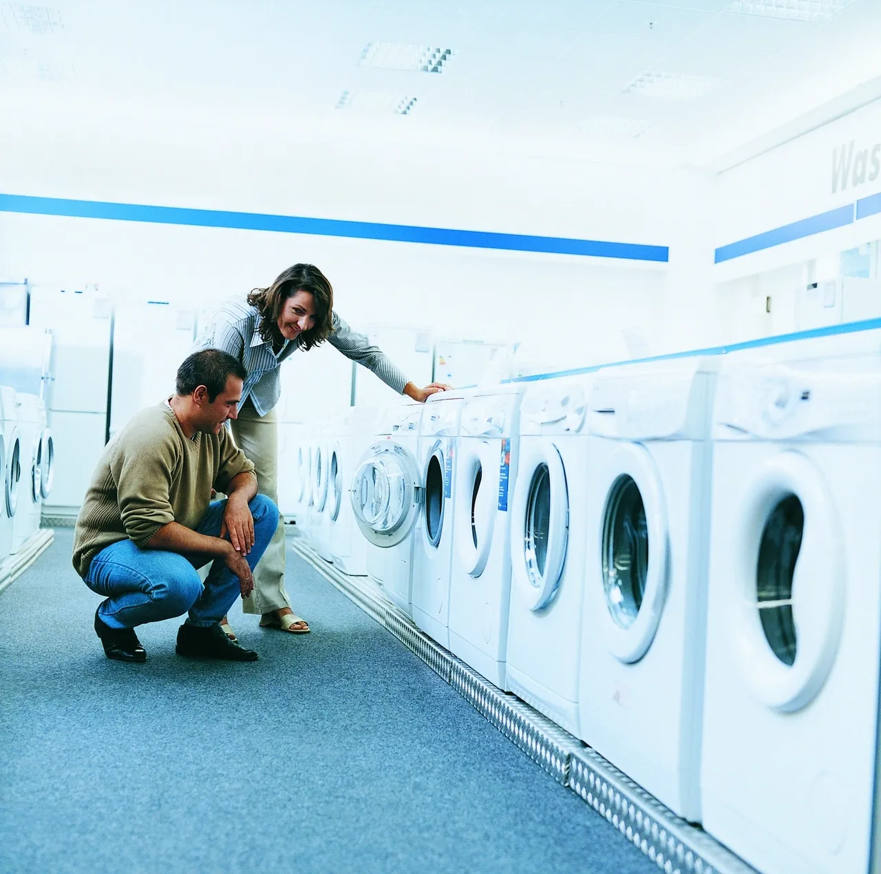 people standing in front of washing machines